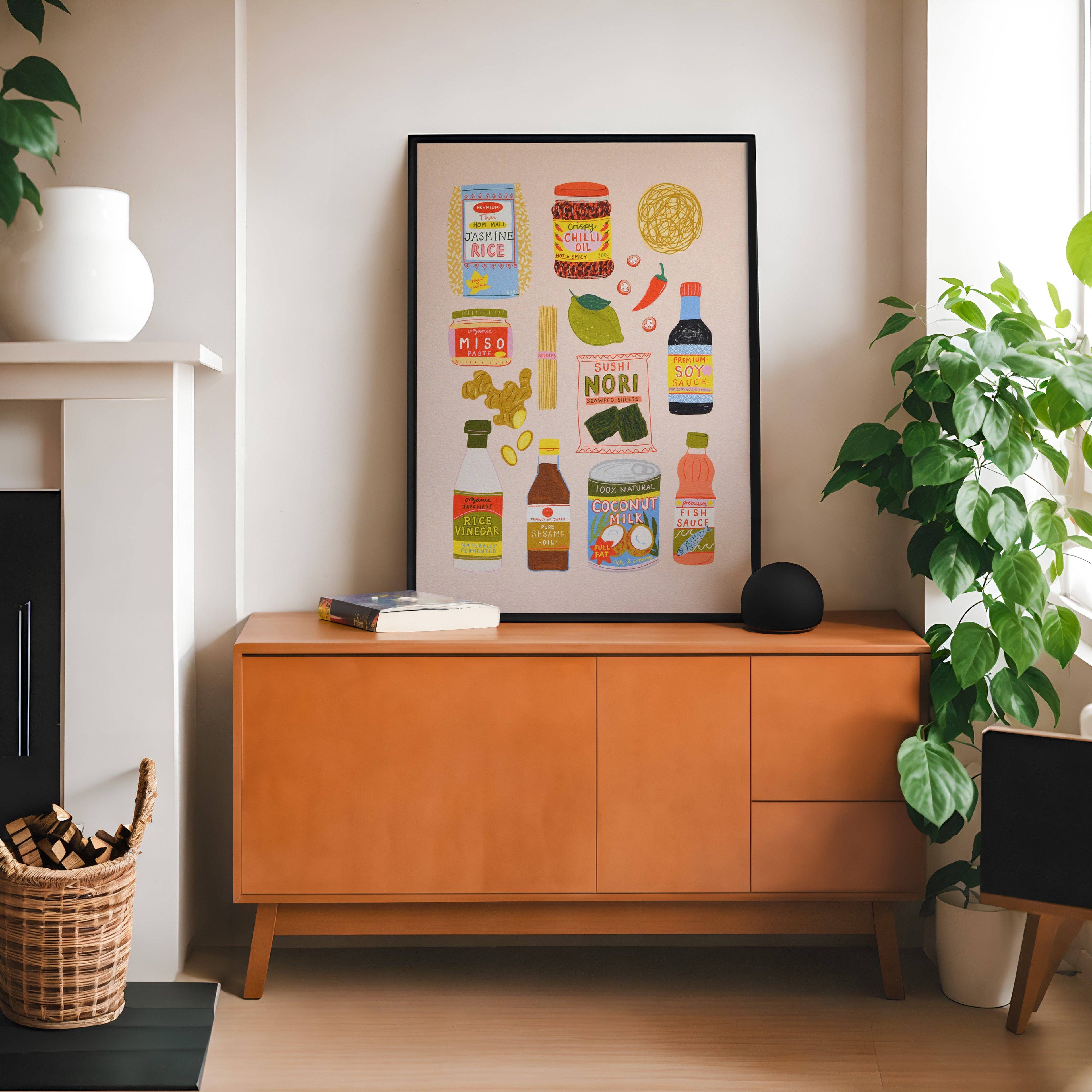 Wooden cabinet with a framed illustrated Asian food poster in a room with plants, a lamp and a just visible fireplace.